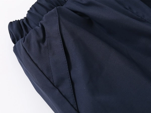 Detail of kids winter fleece pants showing elastic waistband and side pocket construction