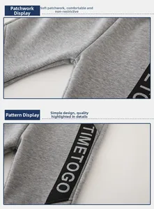 Detail of gray kids joggers featuring soft fabric stitching and side letter print