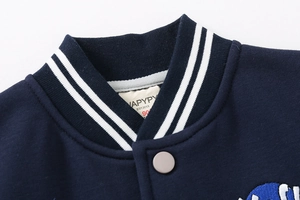 Close-up of striped ribbed collar and metal snap button on kids baseball jacket