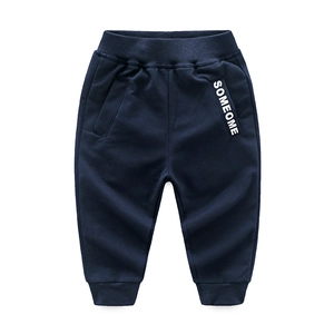 Detailed texture of dark blue kids knit joggers with ribbed waistband and SOMEOME patch