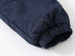 Detail of navy blue winter trousers showing windproof fabric and elastic ribbed ankle cuffs