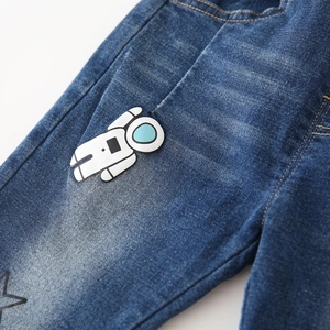 Boys denim jeans with cartoon astronaut patch and star print in classic blue wash
