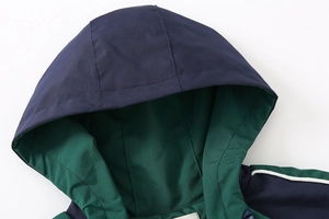 Detail of hood and neckline on navy blue kids jacket with green inner lining