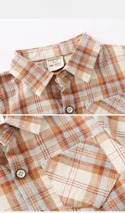 Gros plan du col et de la poche de chemise à carreaux pour enfant avec boutons gravés