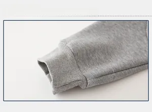 Close-up of gray kids' sweatpants featuring thick ribbed cuffs and warm knitted texture