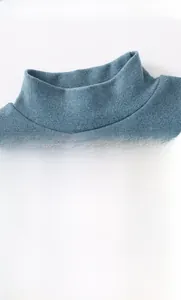 Detail of blue mock neck thermal top for boys with lion embroidery and soft fleece texture
