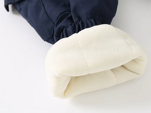 Close-up of kids' winter trousers featuring thick navy outer fabric and warm faux shearling lining