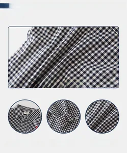 Macro detail of soft black and white checkered fabric with collar and cuff design