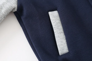 Detail of navy knit fabric with grey contrast pocket stitching on kids jacket