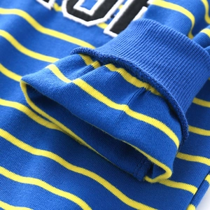 Close-up of blue ribbed cuffs and yellow striped knit fabric on children sweatshirt