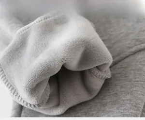 Detail view of thick grey fleece lining on children's warm thermal winter trousers
