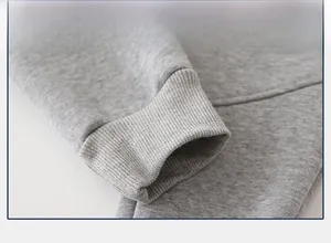 Detail shot of light grey fleece-lined ribbed cuffs on kids dinosaur sweatpants