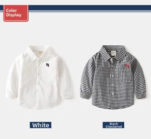 Detail of kids long sleeve shirts featuring embroidered dinosaur pocket in white and plaid