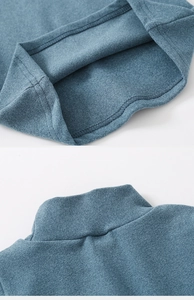 Detail of blue mock neck top showing durable double-needle stitching and soft knit texture