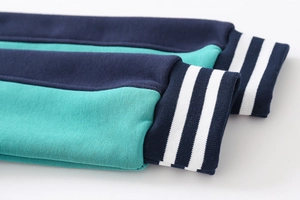 Detail of color-block ribbed cuffs with white stripes on a boys hooded sweatshirt