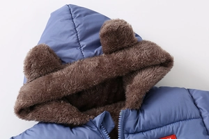 Detail of blue kids hooded jacket with cute bear ears and thick brown faux fur lining