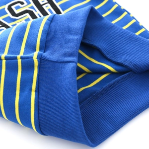 Detail of blue and yellow striped knit sweater with ribbed cuffs and soft cotton texture