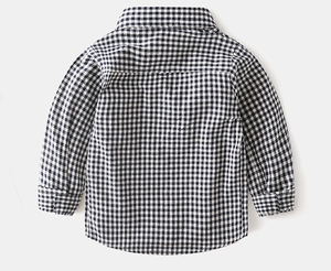 Detailed back view of boy's navy gingham shirt with curved hem and button cuffs