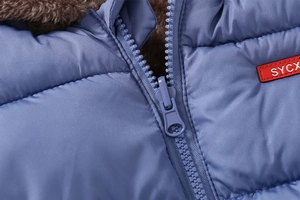 Detail of reversible kids' jacket showing blue outer fabric and brown faux shearling lining