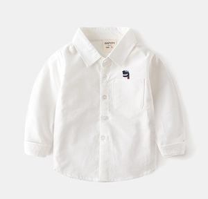 Close-up of a white cotton shirt featuring a cute green dinosaur embroidery on the pocket