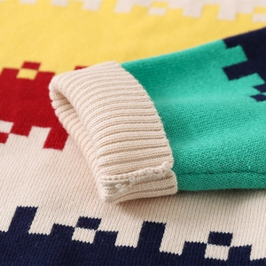 Close-up of colorful striped knit sweater with ribbed cuffs and geometric pattern