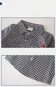 Detailed views of the collar and hem on a black and white checkered kids dinosaur shirt
