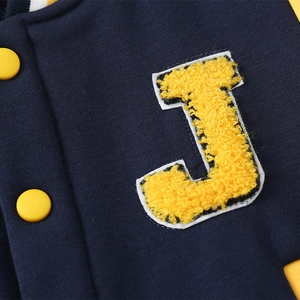Navy blue boys' varsity jacket with yellow chenille J-patch and snap buttons