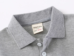 Detail of grey polo shirt collar showing piqué cotton texture and white buttons