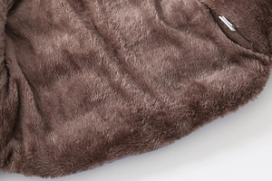 Detailed view of thick brown plush lining for children's winter jackets with a wash tag