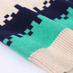 Macro shot of ribbed cuffs and pixel geometric pattern on children's knitted sweater