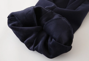 Close-up of thick navy blue fleece lining and soft thermal texture on kids pants