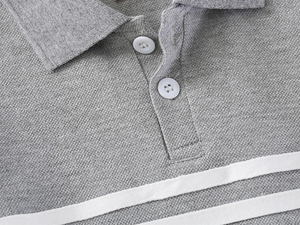 Close-up of boys' grey cotton polo shirt showing ribbed collar and white button detail