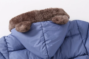 Detail of blue quilted kid's hooded jacket with brown faux fur lining and cute animal ears