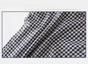 Close-up of black and white gingham cotton fabric showing detailed texture and weave