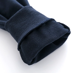 Detail of ribbed cuffs and soft fleece lining on dark blue knit children's sweater