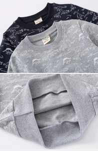Detail of ribbed hem and high-quality cotton texture on dinosaur print kids sweatshirt