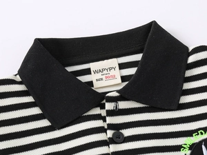 Detail of children's striped polo shirt collar with branded label and green embroidery