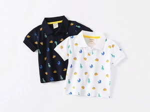 Close-up of navy and white cotton polo shirts with colorful cartoon dinosaur prints