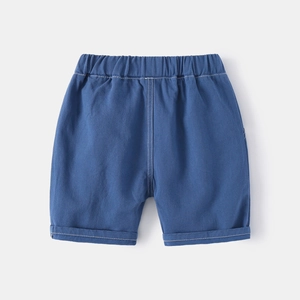 Detail of dark blue boys shorts with white contrast stitching and elastic waistband