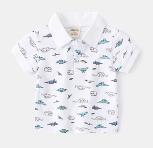 Detail of children's white cotton polo shirt with colorful dinosaur and elephant prints