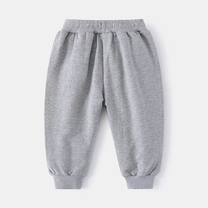 Detail of gray kids joggers showing ribbed elastic waistband and soft cotton fabric