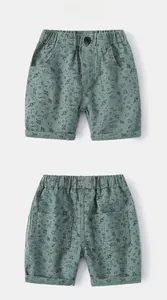 Detailed back and front view of space-themed boys' cotton shorts with UFO prints