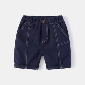 Detail of navy blue boys cotton shorts featuring elastic waist and contrast white stitching