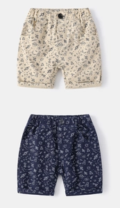 Close-up of kids space print cotton shorts featuring UFO and planet patterns