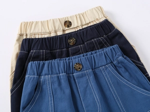 Close-up of boys' cotton shorts showing elastic waistbands and contrast stitching
