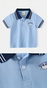 Detail of light blue boys' polo shirt with cat embroidery and navy striped collar