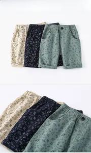 Close-up of cotton kids' shorts with space themed prints and elastic waistband detail