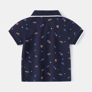 Detail view of navy blue boys polo shirt with space rockets and planets pattern