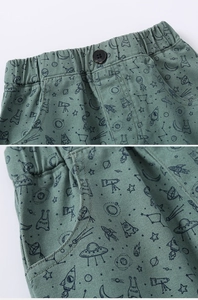 Detail of kids cotton shorts with elastic waistband and alien spaceship space patterns