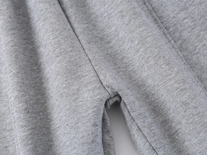 Close-up of grey marl knit fabric showing fine stitching and soft cotton texture